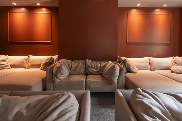 Sala de cinema com sofás e iluminação ambiente